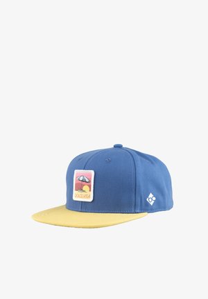 Blue and yellow cap with flat brim, featuring a "Dolce Vita" patch showing a beach umbrella and sunset.