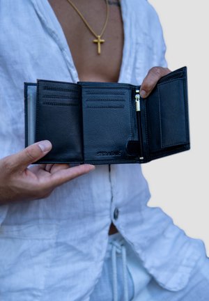 Black leather wallet with multiple card slots, a zippered coin pocket, and a smooth textured finish, held open in a hand.