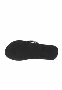 Suola di sandalini in gomma nera con una superficie texturizzata, forma arrotondata e due indentazioni circolari per la presa. Design piatto con dettagli minimi.