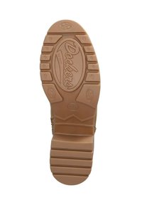 Tan rubber outsole with multidirectional tread pattern, featuring "Dockers" logo embossed in the center. Smooth texture and sturdy design.