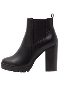 Černé kožené kotníkové boty s masivním vysokým podpatkem, elastickou boční částí, táhlem na obouvání a texturovanou gumovou podrážkou.