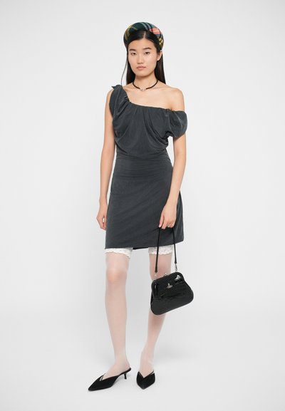 Vestido cinza sem alças com tecido franzido, design ajustado e acabamentos em renda. Bolsa preta com padrão de crocodilo e sapatos pretos de salto pontiagudo.