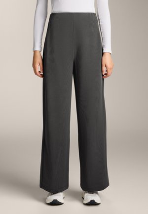 Wide-leg pants in dark gray ribbed fabric, featuring a high waist and clean lines, styled with white long-sleeve top and white sneakers.