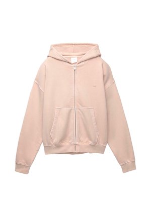 Haut de sweat à capuche rose zippé, fabriqué en tissu doux. Comprend une poche avant, une capuche réglable et des poignets côtelés. Design simple avec un minimum de détails.