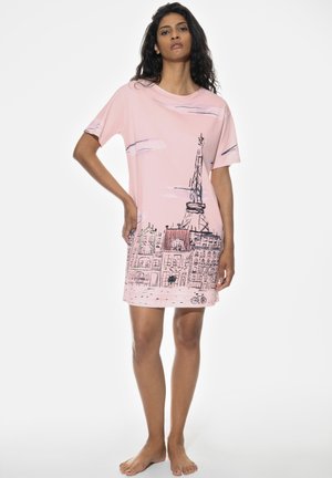 Pink cotton dress featuring a cityscape print with a tower and buildings, short sleeves, and a relaxed fit, reaching mid-thigh.