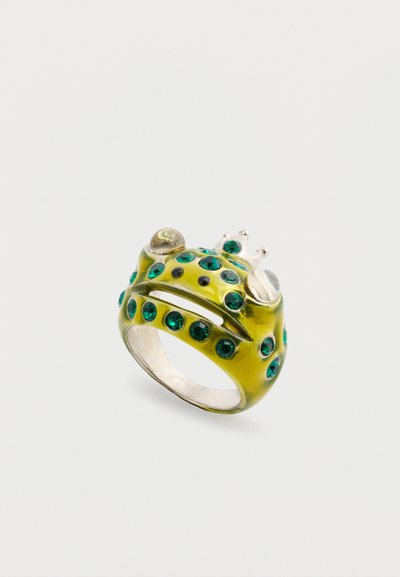 Frog-shaped ring featuring a glossy yellow finish, green gem eyes, and a silver crown accent. Textured with small indentations around eyes.