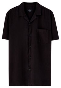 Chemise noire à manches courtes en tissu lisse, avec un col classique, une fermeture à boutons sur le devant et une poche poitrine unique.