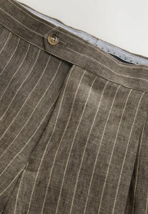 Brown linen pants with vertical white stripes, featuring a button closure and a textured fabric. Edges are neatly finished.