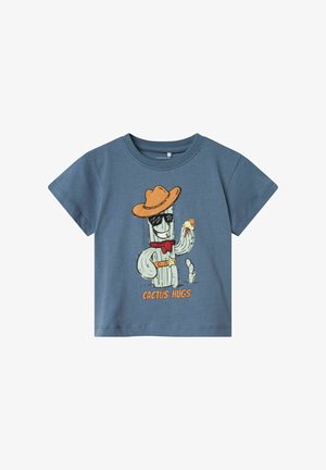 Blauwe katoen t-shirt met een cartoon cactus karakter dat een cowboyhoed, zonnebril en een rode bandana draagt, met de tekst "CACTUS HUGS" eronder.