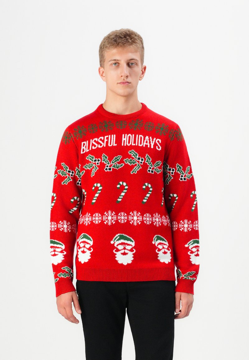 Rode gebreide trui met de tekst "BLISSFUL HOLIDAYS", feestelijke patronen met kerstman gezichten, zuurstokken en hulst. Ribgebreide manchetten en zoom.