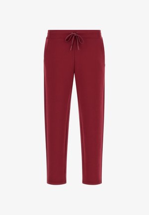 Burgundy sweatpants made of soft fabric, featuring an elastic waistband with a drawstring, side pockets, and tapered legs.