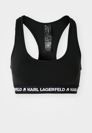 Schwarzer Sport-BH mit Racerback-Design, aus elastischem Stoff gefertigt. Verfügt über ein weißes Band mit dem "KARL LAGERFELD"-Logo und einem QR-Code auf dem Etikett.