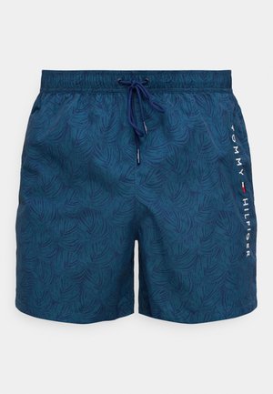Mørkeblå badeshorts med et strukturert løvmønster, med elastisk midjebånd med snor og logodetalj på siden.