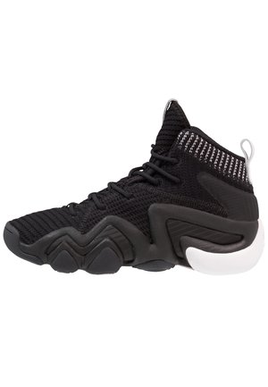 High-top athletic shoe with a black woven mesh upper, textured accents, and a chunky white rubber sole featuring zigzag patterns.