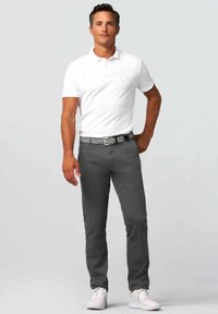 White polo shirt, gray pants, patterned belt. Casual outfit with a fitted design, solid colors, and white sneakers. Clean and modern look.
