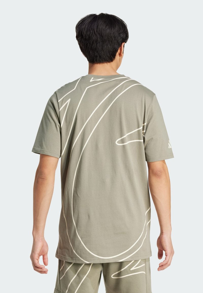 Khaki cotton t-shirt featuring white abstract line designs on the back. Short sleeves and a relaxed fit with a crew neckline.