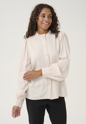 Helles rosa Bluse mit einem gerafften Ausschnitt, Knopfleiste und Puffärmeln. Verfügt über perlenartige Knöpfe und geraffte Manschetten für zusätzliche Details.