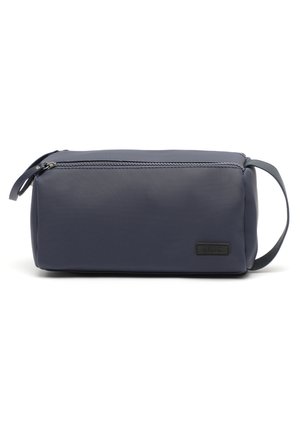 Navy blue rectangular toiletry bag made of textured material with a zipper closure and a side handle. Features a logo patch on the front.