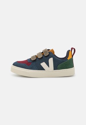 Suede sneakers with a varied color scheme of navy, burgundy, green, and yellow; features three velcro straps and a white rubber sole.