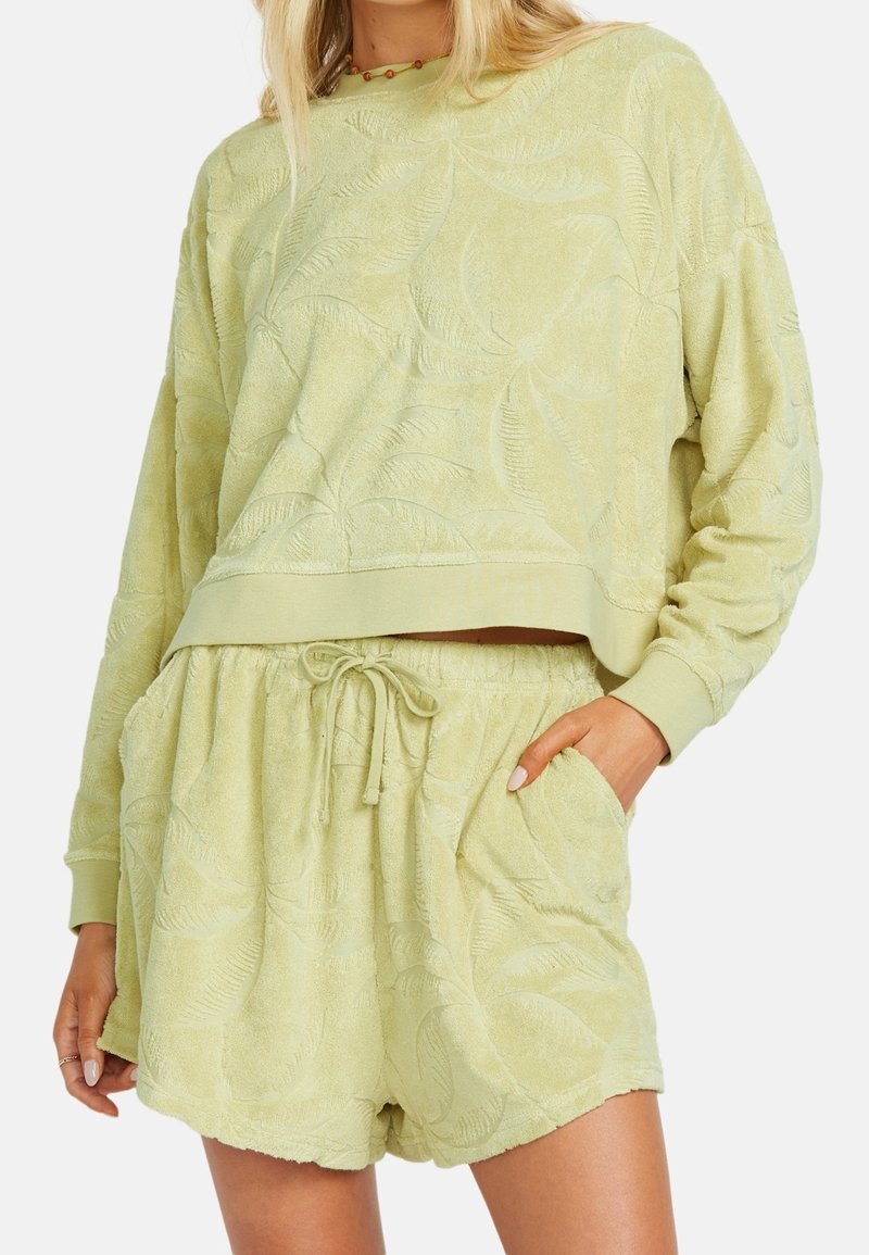 Hellgrüne Frottee-Shorts und dazu passendes, kurz geschnittenes Sweatshirt mit einem strukturierten Blattmuster. Elastischer Bund mit verstellbarem Kordelzug.
