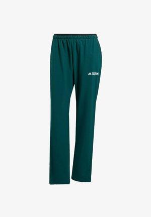 Pantalones deportivos verdes con cintura elástica, con un acento negro y el logo blanco "TERRE" en la pierna izquierda. Hechos de un material ligero.