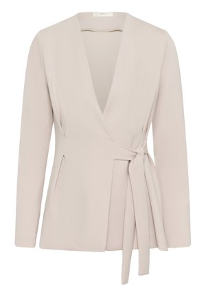 Blazer long beige clair à manches longues avec col en V profond et détail de ceinture latérale, coupe ajustée, sans boutons ni col.