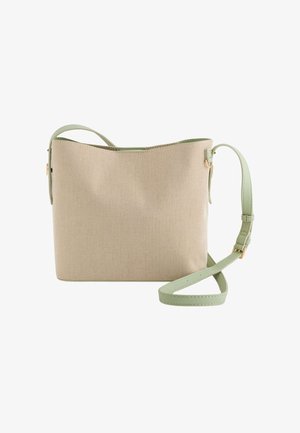 Beige texturovaná kabelka s nastavitelným zeleným popruhem, s hladkým povrchem a minimalistickým designem. Obsahuje akcenty z kvalitního zlatého kovu.