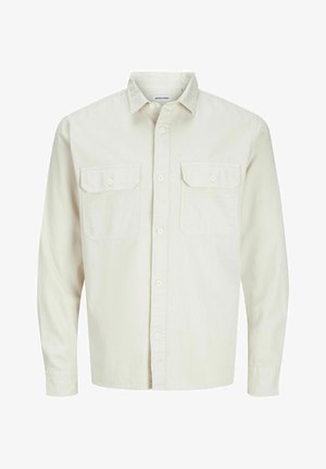 Light beige button-up shirt with long sleeves, two chest pockets, and a collar. Made of cotton with a smooth texture and relaxed fit.