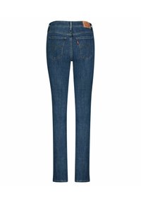 Mörkblå denim skinny jeans med midja, som har två bakfickor och en läderlogotyp ovanför midjebandet. Slät textur.