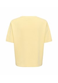 T-shirt jaune clair uni à manches courtes avec une coupe décontractée, vu de dos sur fond blanc.