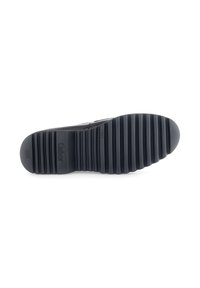 Black rubber sole with ridged texture. Curved edge and slight heel, featuring brand logo embossed. Smooth surface with a matte finish.