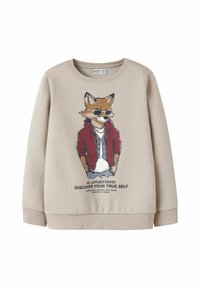 Bež sweatshirt s grafikom lisice u naočalama i crvenoj jakni, s natpisom "Budi avanturističan, otkrij svoju pravu prirodu" ispod.