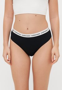 Black cotton bikini panties with a white logo band featuring "BJÖRN BORG." The fabric has a smooth texture and mid-rise design.