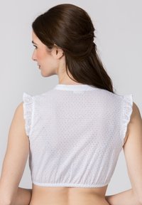 White, short-sleeve crop top with ruffled sleeves and a textured eyelet pattern. Features a rounded neckline and elasticated hem.