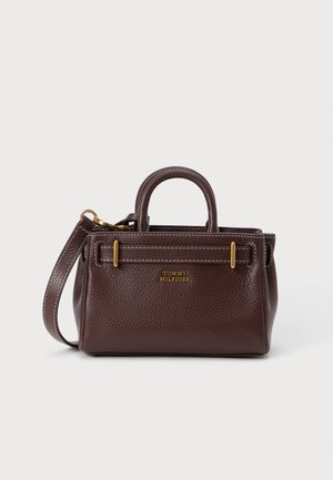 Brown leather handbag with a structured design, gold hardware accents, short handles, and a detachable shoulder strap.