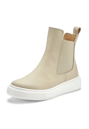 Beige leather Chelsea boot featuring a smooth finish, elastic side panels, a white rubber sole, and a textured accent at the back.