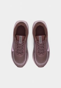 Pair of brown and pink Nike running shoes with laces, viewed from above against a plain white background.