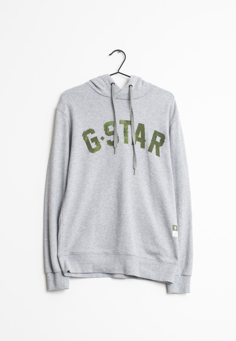 Šedá mikina s kapucí, s velkým zeleným nápisem "G-STAR". Vyrobena z měkkého materiálu s žebrovanými manžetami a dolním lemem. Visí na černém háčku.