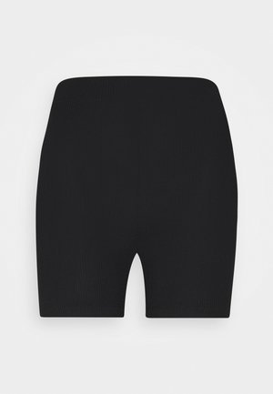 Short cycliste noir côtelé à taille haute, longueur mi-cuisse et coupe ajustée, présenté sur un fond blanc uni.