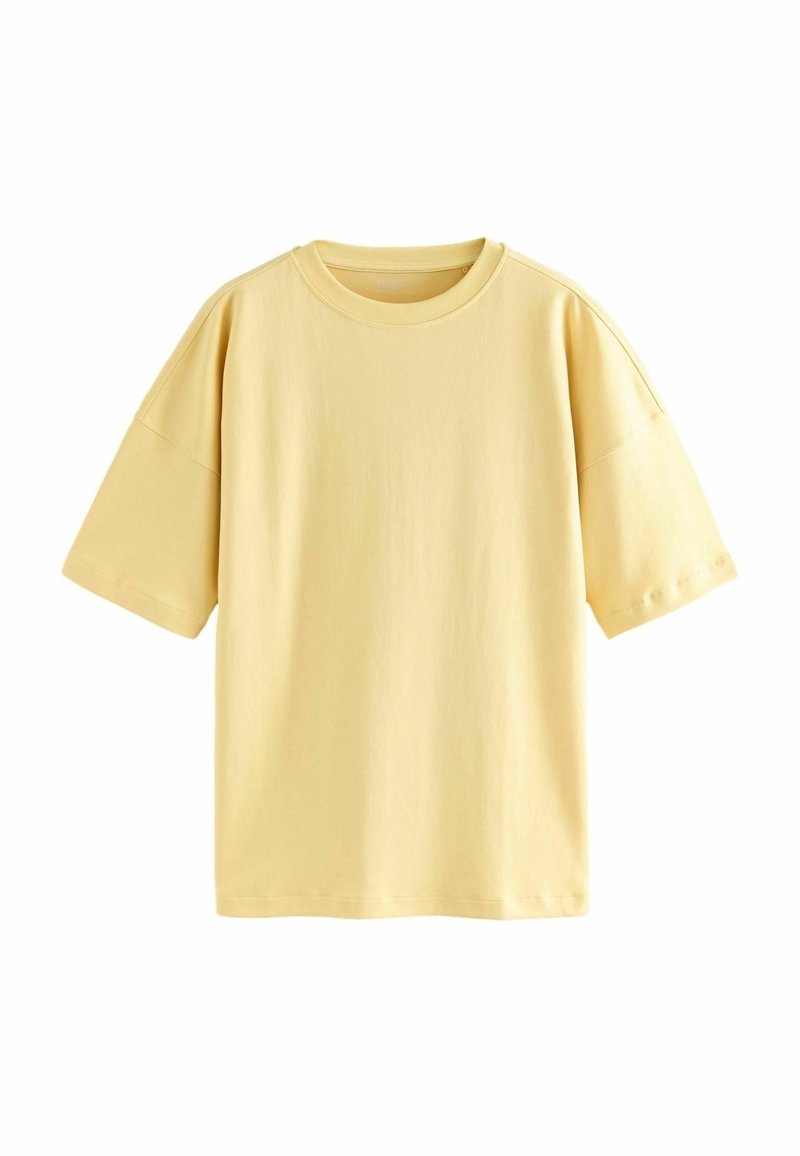 Camiseta de algodón amarilla clara con un corte holgado, mangas cortas y escote redondo. Textura suave y sin patrones ni acentos.
