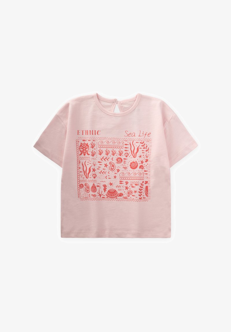 Šviesiai rožinė trumpomis rankovėmis marškinėliai su koraline jūros gyvybės grafika, kurioje pavaizduoti įvairūs vandenyno dizainai ir raktų angos detalė nugarinėje pusėje.