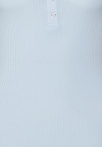 Light blue ribbed tank top with a fitted design, featuring a button placket at the neckline and minimalistic silver hardware accents.