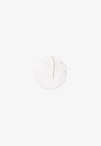 Crema bianca circolare con una consistenza liscia, dotata di minimal dettagli superficiali e un bordo leggermente irregolare.