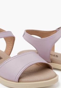 Lilac leather sandals featuring a two-band design, an ankle strap, and a beige cushioned footbed with textured sole.