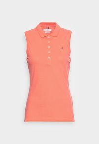 Ärmelloses korallenfarbenes Poloshirt mit fünf Knöpfen auf der Vorderseite und kleinem Tommy Hilfiger Logo auf der Brust, vor weißem Hintergrund präsentiert.