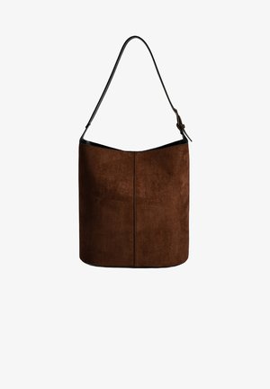 Brown suede shoulder bag with a curved top, thin black strap, and a smooth texture. Features a minimalist design and no visible hardware.