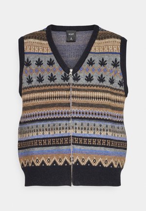 Mouwloos gebreid vest met een V-hals, voorzien van kleurrijke geometrische patronen in blauw-, bruin- en zwarte tinten. Ritssluiting aan de voorkant.