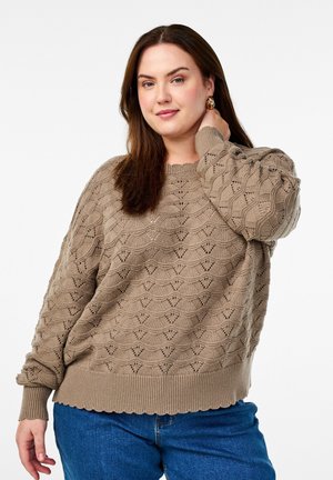 Light brown knitted sweater with a textured, geometric pattern and ribbed hem. Rounded neckline and slightly puffed sleeves.