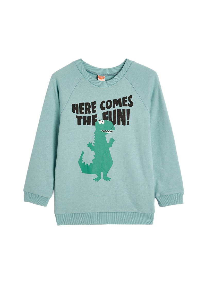 Sudadera de algodón azul claro con mangas raglán, que presenta un gráfico de un dinosaurio verde y un texto negro que dice "¡AQUÍ VIENE LA DIVERSIÓN!"