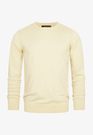 Pull en tricot jaune clair avec un col rond, des manches longues, des poignets et un ourlet côtelés. Texture lisse et design simple.